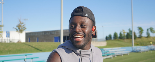 Canadian sprinter Sam Effah wearing Shokz OpenRun wireless headphones